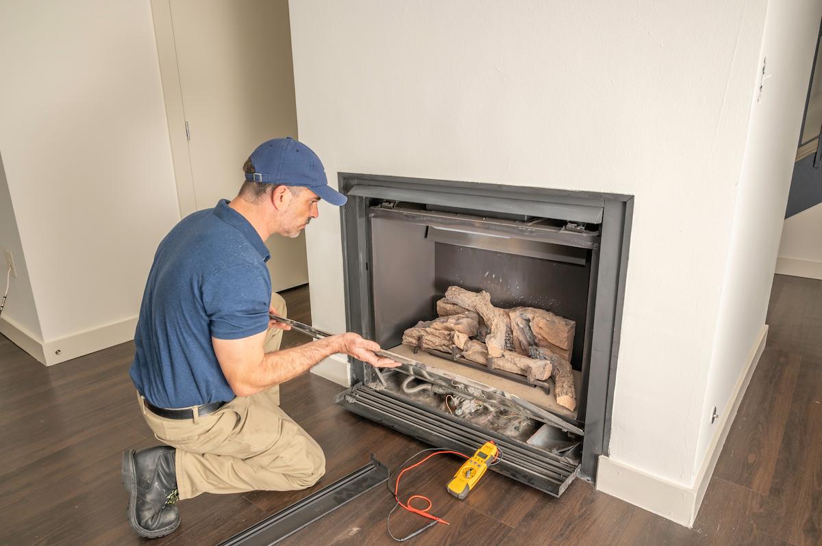 artisan termine la renovation d'une cheminee 