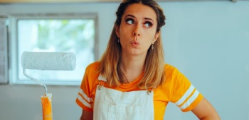Femme tient rouleau de peinture