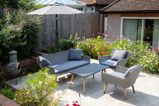 Petite terrasse devant une maison avec une table pour quatre